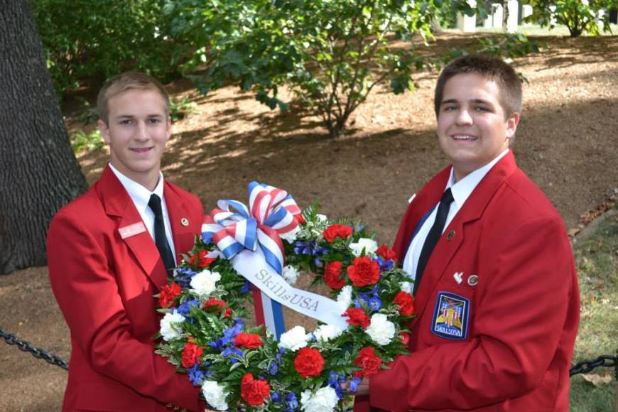 National Officers Matt Carder (left) and Ben Miller (right) pose with the SkillsUSA wreath before the ceremony.
